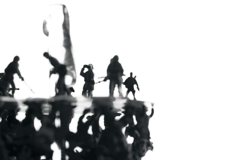 Black and white detail of Digital war by Federico Clapis: silhouettes of toy soldiers on the disc against a bright white background