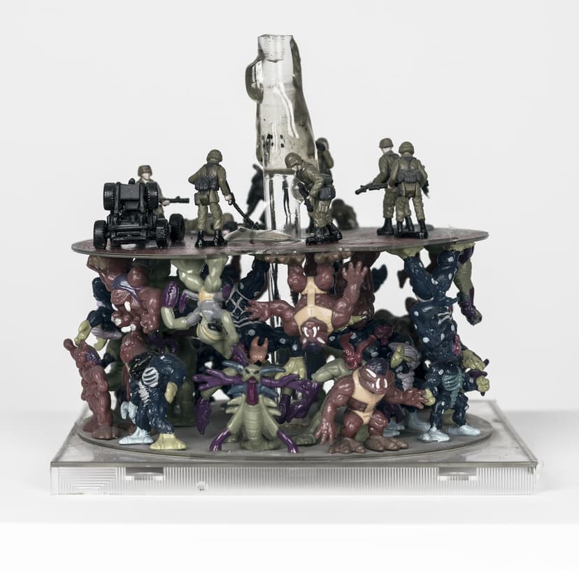 Another side of Digital war by Federico Clapis: soldiers with a cannon on the disc above a crowded tower of colourful toy monsters