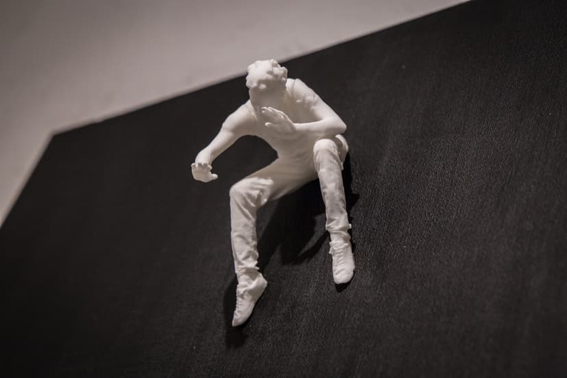 Fear Of Fusion by Federico Clapis, close-up of the white crouching figure raising his hands as if to protect himself, on black canvas