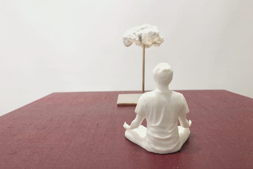 Levitation by Federico Clapis, rear view: white figure sitting cross-legged facing a white cloud on a brass rod, on a dark red canvas