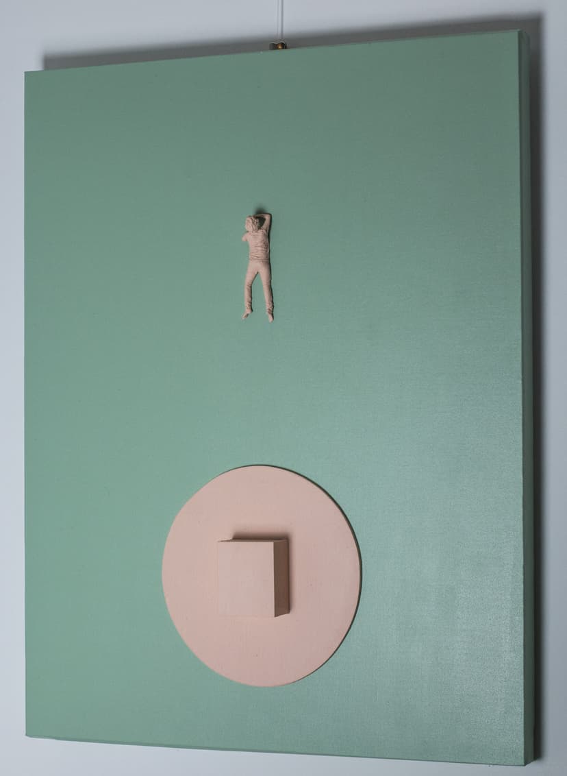 Mother by Federico Clapis hanging on a wall, seen at an angle: green canvas, tiny pink resin figure and a raised pink disc