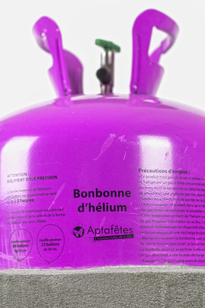 Self Portrait by Federico Clapis, close view: the valve and handles of a purple helium canister labelled Bonbonne d'hélium