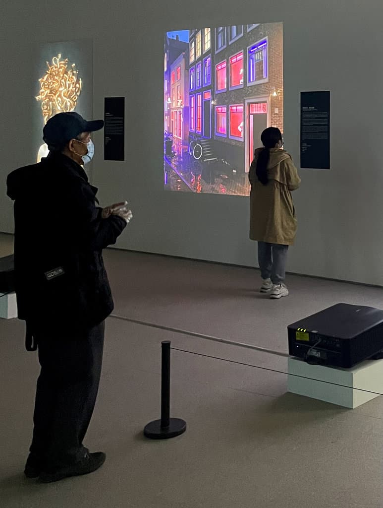 Installation view of Crypto Art: A New Possibility at CAFA Art Museum, Beijing: Federico Clapis' projected red-light street scene and its projector