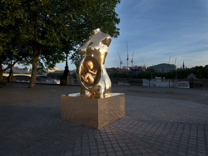 Crypto Connection by Federico Clapis at dusk on the South Bank promenade in London, under the trees beside the Thames railings