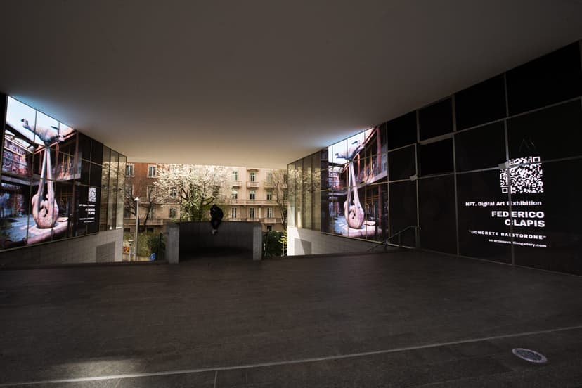 LED walls under a canopy at Piazza Gae Aulenti showing Concrete Babydrone and a QR code caption for Federico Clapis's NFT