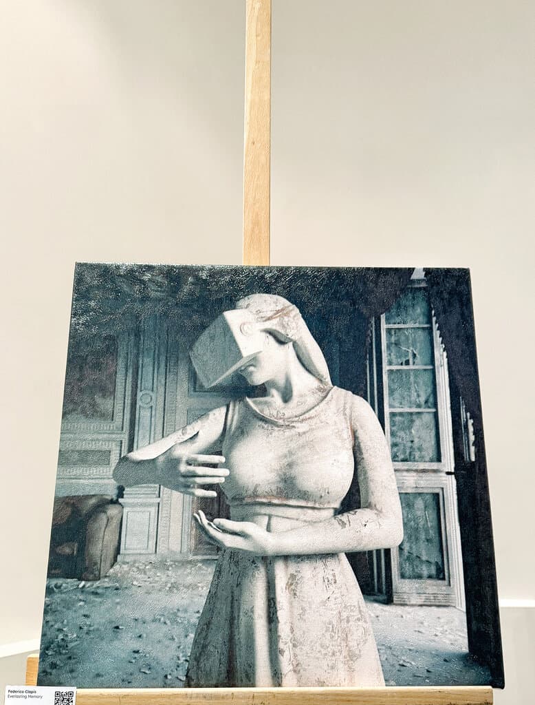Everlasting Memory by Federico Clapis on an easel: a white statue of a woman in a VR headset in a ruined interior, shown during NFT Paris