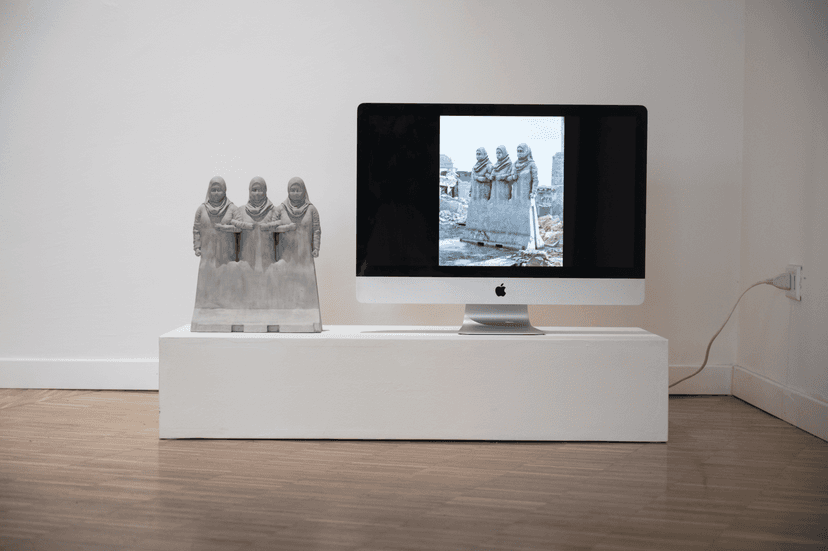 Sculpture of three veiled female figures beside a monitor showing a similar group, a work by Federico Clapis at Bianchi Zardin gallery in Milan