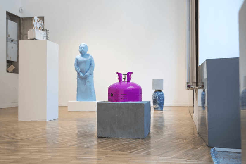 Installation view at Bianchi Zardin, Milan: blue female figure, magenta canister on concrete and capped vase in Federico Clapis' solo show